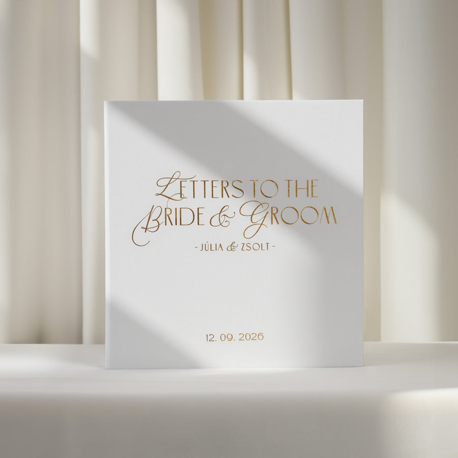 Personalized silky white linen wedding letters keepsake book with real gold foil reading "Letters to the Bride & Groom" displayed on a white backdrop.