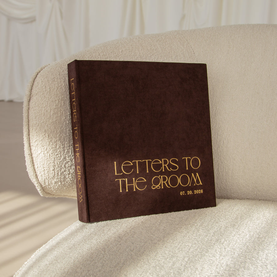 Brown book titled 'Letters to the Groom' on a beige couch