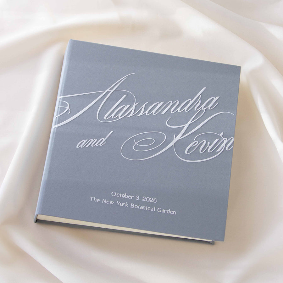 Personalized Dusty Sky Blue Polaroid guest book with White Velour lettering displayed upright in natural light.